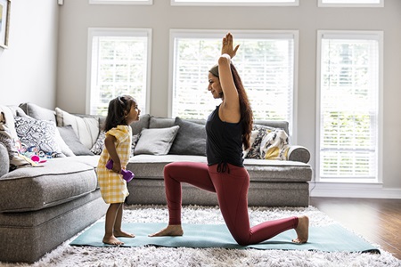 A mother and daughter exercise together.