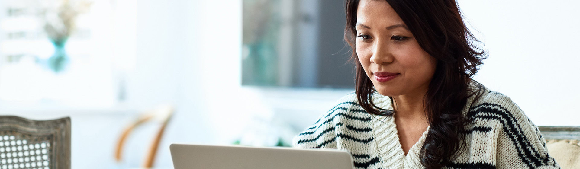 Young woman using laptop to access patient portal